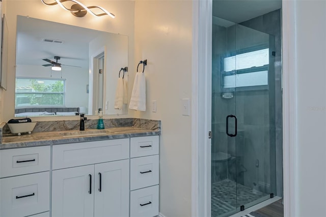 bathroom featuring vanity, an enclosed shower, and ceiling fan