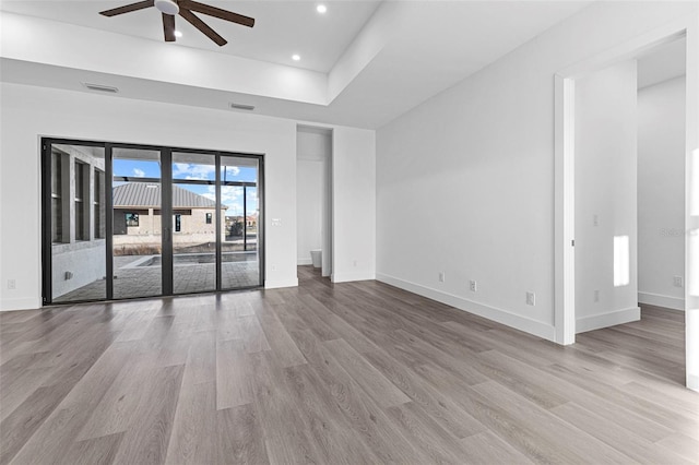 unfurnished living room featuring ceiling fan and light hardwood / wood-style flooring