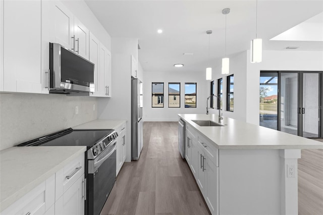 kitchen featuring white cabinets, sink, and appliances with stainless steel finishes