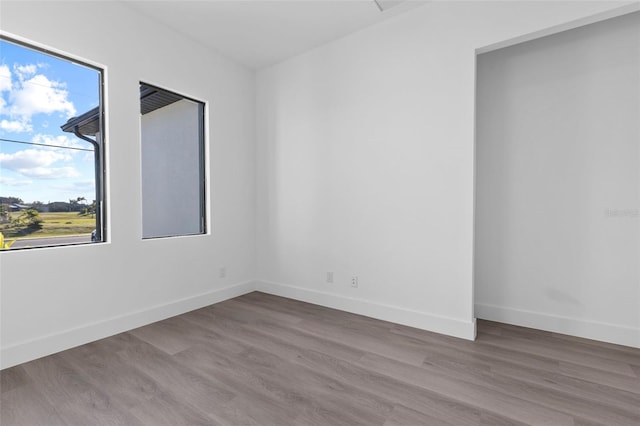 spare room with hardwood / wood-style floors