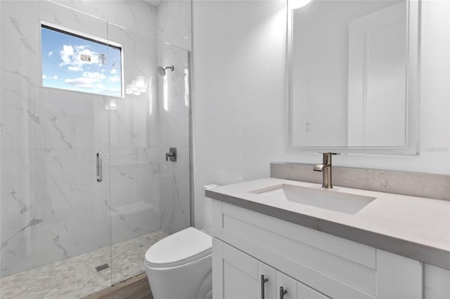 bathroom with hardwood / wood-style flooring, vanity, toilet, and a shower with shower door