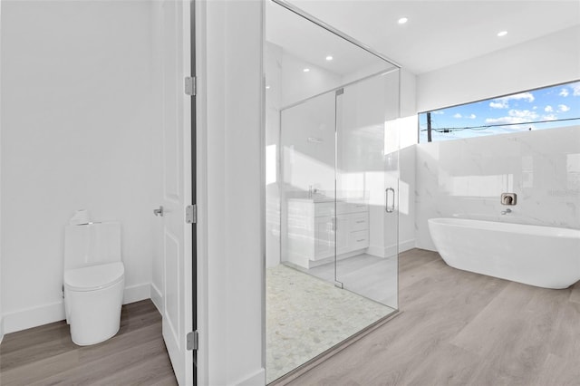 bathroom featuring wood-type flooring, toilet, and independent shower and bath