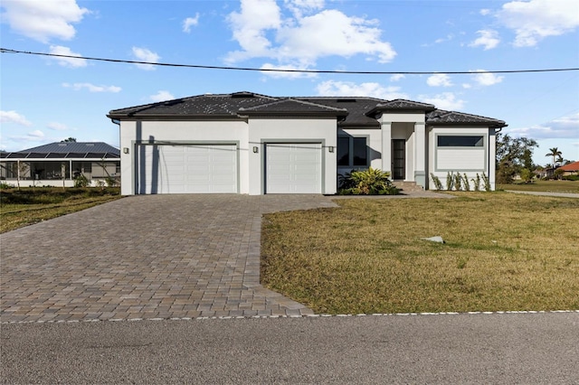 view of front of property featuring a garage and a front lawn