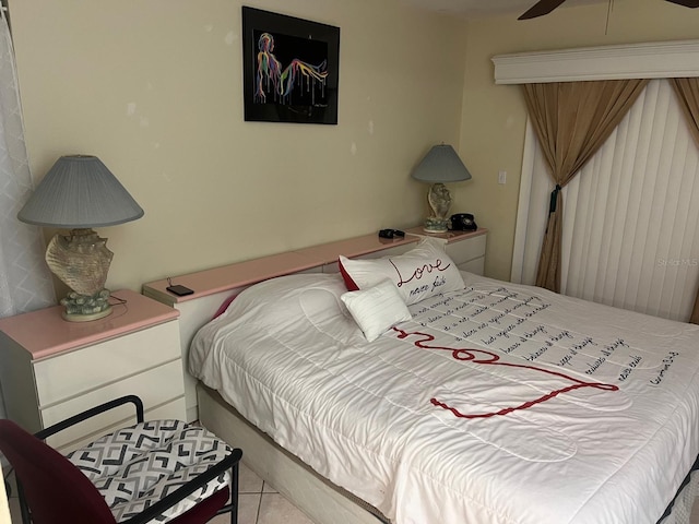 tiled bedroom featuring ceiling fan