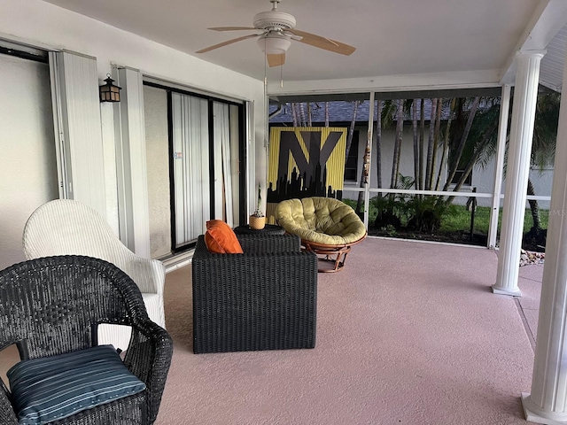 sunroom / solarium featuring ornate columns and ceiling fan