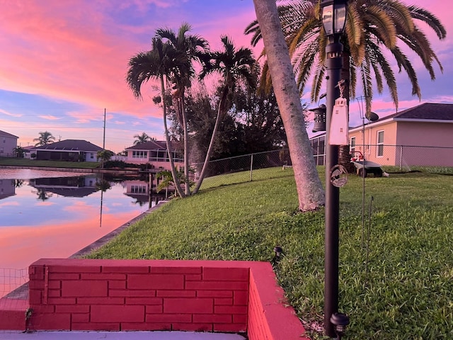 yard at dusk with a water view