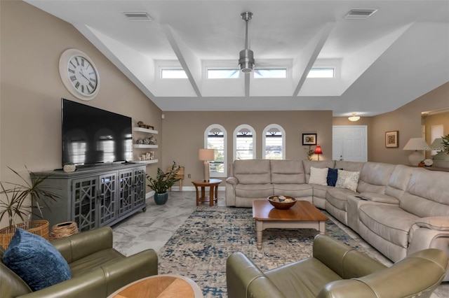 living room featuring lofted ceiling with skylight and ceiling fan