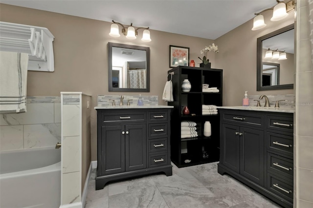 bathroom with vanity and independent shower and bath