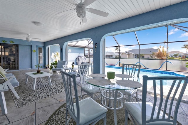 view of patio / terrace with glass enclosure and ceiling fan