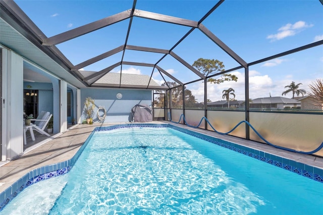 view of swimming pool with a patio and a lanai