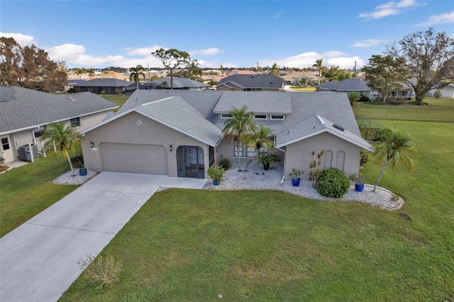 ranch-style house with a front yard, central AC unit, and a garage