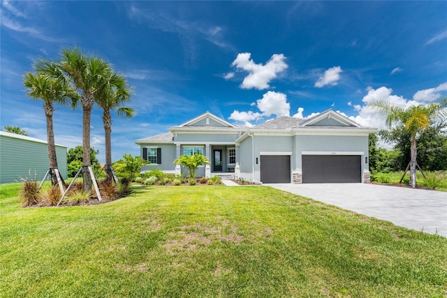 view of front of house with a front yard and a garage