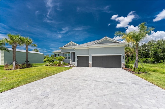 view of front of property with a front lawn and a garage