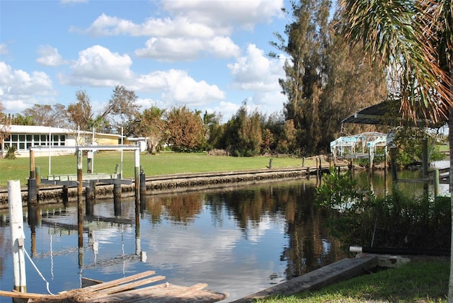 view of dock featuring a yard and a water view