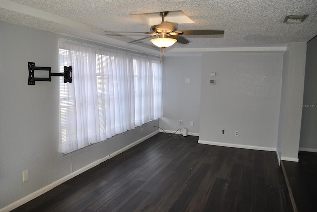 spare room with a textured ceiling, dark hardwood / wood-style floors, and ceiling fan