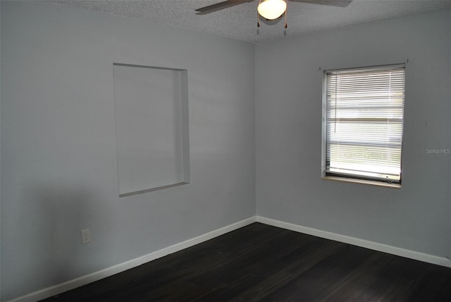 spare room with ceiling fan, a textured ceiling, and dark hardwood / wood-style flooring