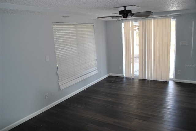 empty room featuring a textured ceiling, dark hardwood / wood-style floors, and ceiling fan