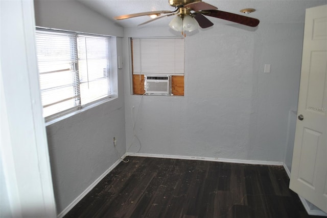 empty room with dark hardwood / wood-style flooring, cooling unit, ceiling fan, and vaulted ceiling