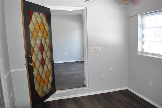 spare room with ceiling fan and dark hardwood / wood-style flooring