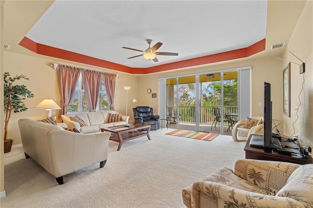 carpeted living room with plenty of natural light and ceiling fan