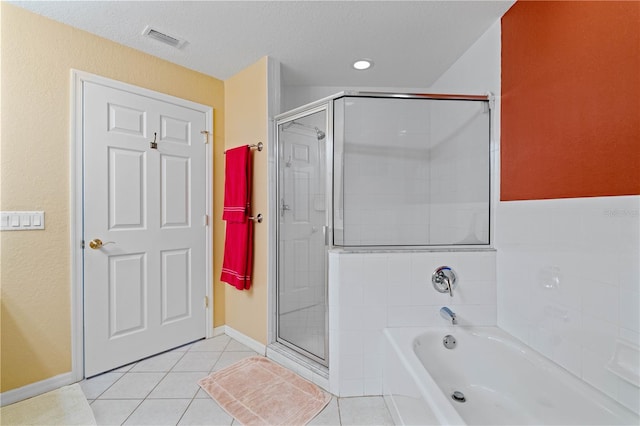 bathroom featuring a textured ceiling, shower with separate bathtub, and tile patterned floors