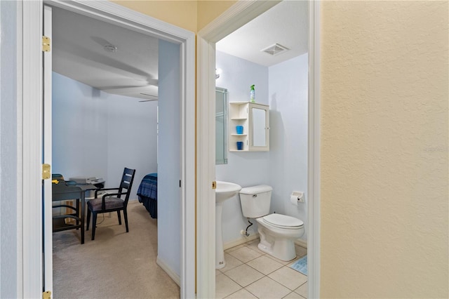 bathroom with toilet and tile patterned floors