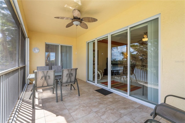 sunroom featuring ceiling fan