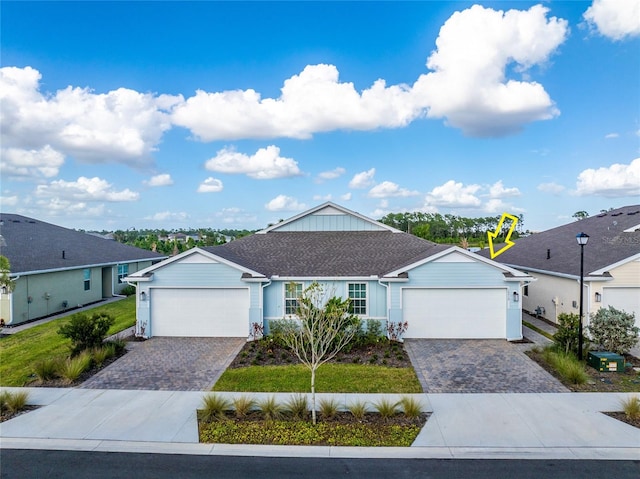 ranch-style home with a front lawn and a garage