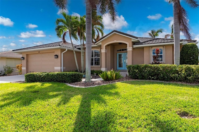 view of front of home with a garage and a front lawn