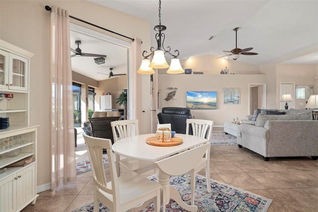 dining space featuring ceiling fan, light tile patterned floors, and lofted ceiling