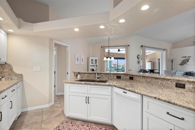 kitchen featuring dishwasher, white cabinetry, light tile patterned floors, sink, and light stone counters