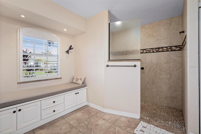 bathroom featuring vanity and a tile shower