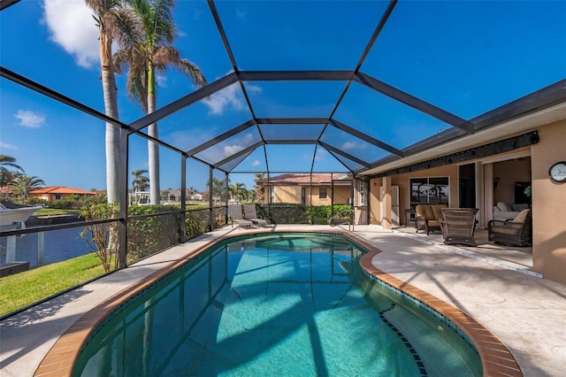 view of pool with glass enclosure, a patio area, a water view, and outdoor lounge area