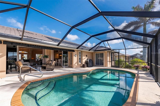 view of swimming pool featuring glass enclosure and a patio