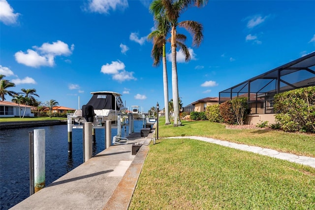 view of dock with a water view, a lanai, and a yard