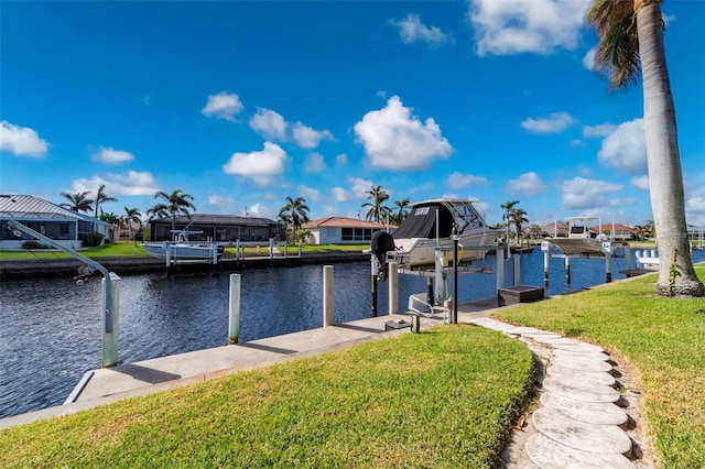 view of dock featuring a water view and a yard