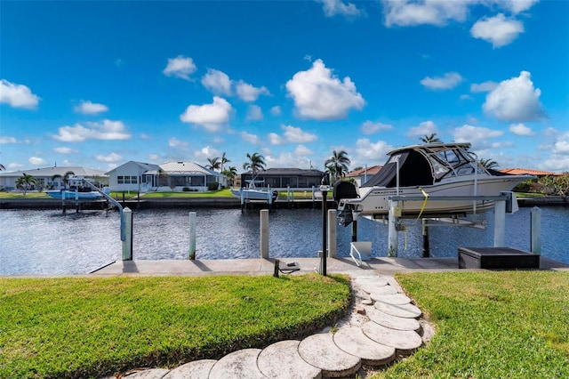 view of dock with a water view and a yard