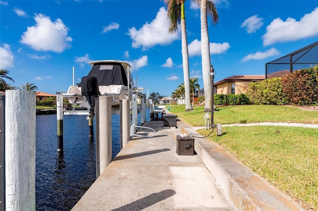 dock area with a water view and a lawn