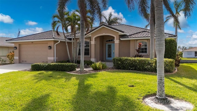 view of front of home featuring a garage and a front lawn