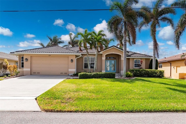 view of front of house with a garage and a front yard