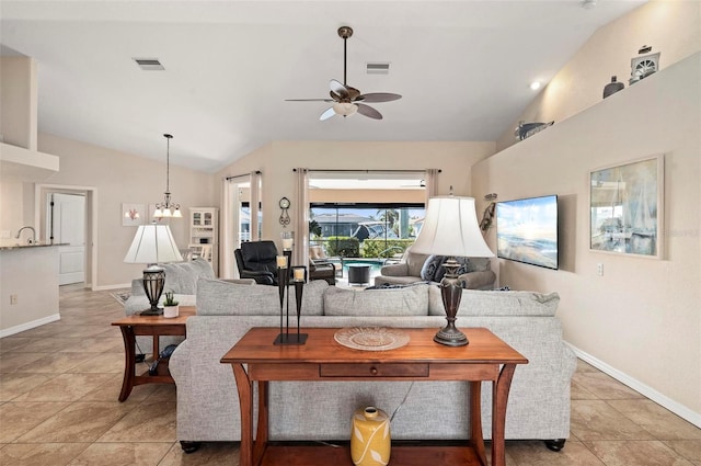 living room with ceiling fan with notable chandelier, sink, light tile patterned floors, and vaulted ceiling