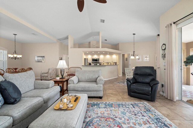 living area with light tile patterned floors, lofted ceiling, visible vents, baseboards, and ceiling fan with notable chandelier