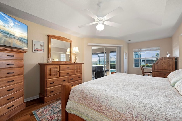 bedroom featuring dark wood-type flooring, access to exterior, and ceiling fan