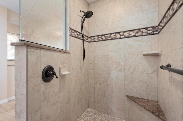 bathroom with a tile shower