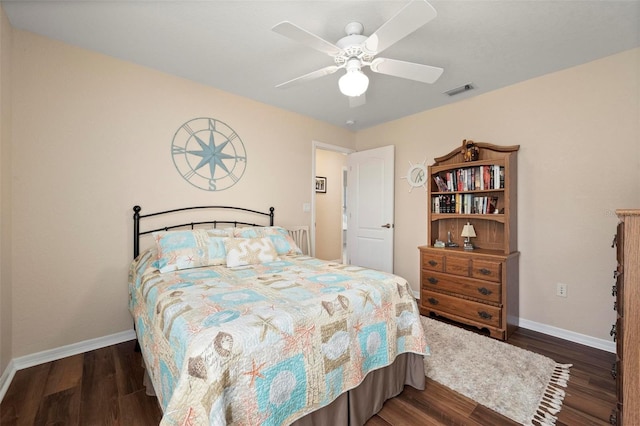 bedroom featuring ceiling fan, wood finished floors, visible vents, and baseboards