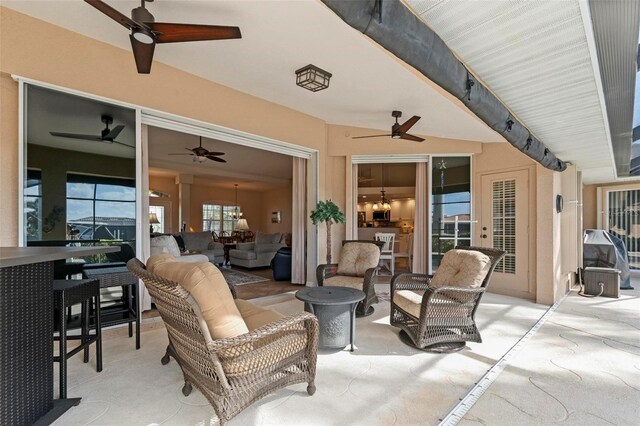 view of patio with ceiling fan and outdoor lounge area