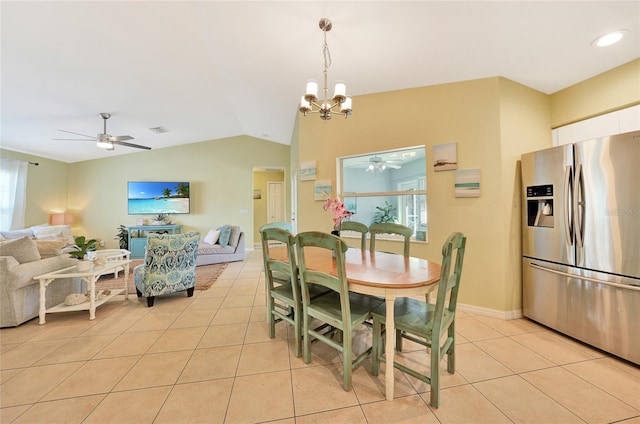 dining room with vaulted ceiling, light tile patterned flooring, and ceiling fan with notable chandelier