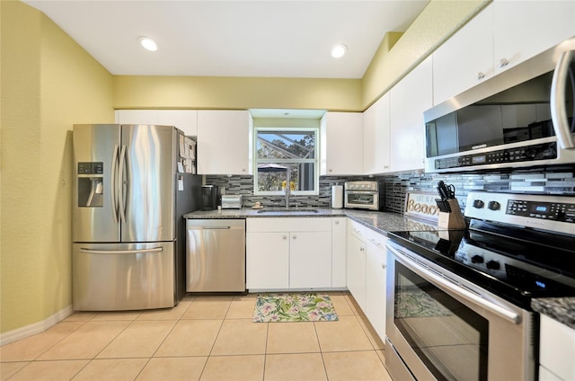 kitchen featuring white cabinets, sink, appliances with stainless steel finishes, and tasteful backsplash