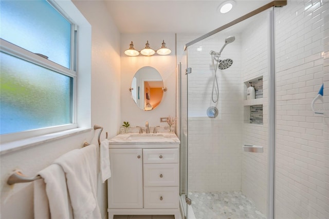 bathroom featuring vanity and a shower with shower door