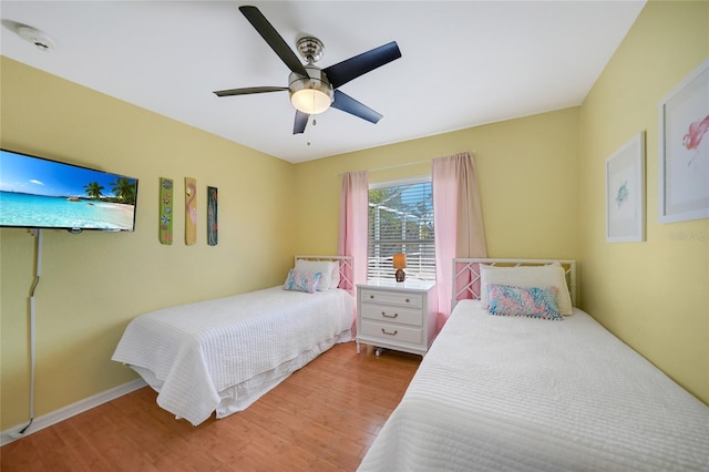 bedroom with ceiling fan and light wood-type flooring